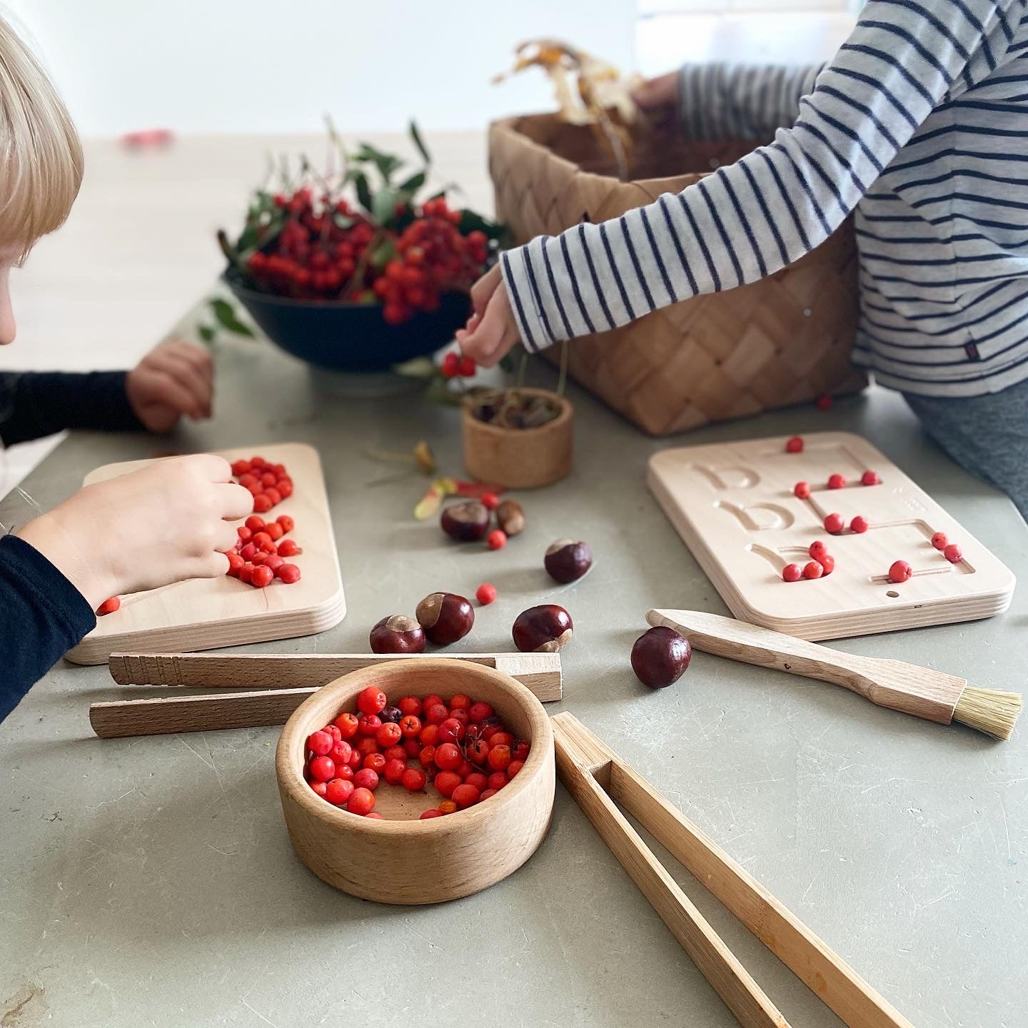 a boy playing good wood preschool wooden board