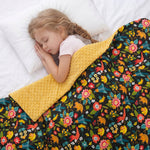 girl sleeping under the Birds'n'Flowers weighted blanket