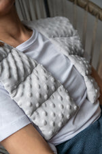 woman wearing long minky weighted collar  in light grey shade made by sensory owl 